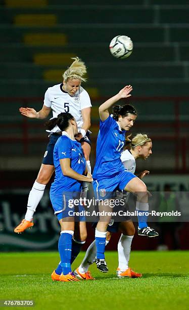 Steph Houghton of England heads the ball over players from Italy during their women's Cyprus Cup match on March 5, 2014 in Larnaca, Cyprus.