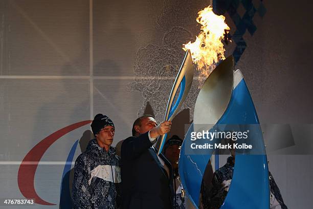Sochi Mayor Anatoly Pakhomov lights the the Paralympic torch at Rosa Khutor on March 5, 2014 in Sochi, Russia.