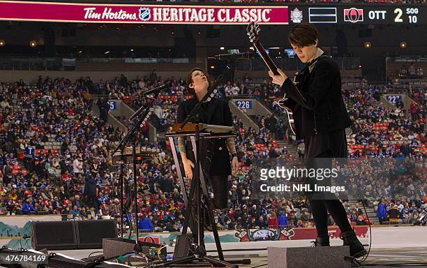 Tegan and Sara perform during the first intermission of the 2014 Tim Hortons Heritage Classic game between the Ottawa Senators and the Vancouver...
