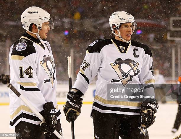 Chris Kunitz talks with Sidney Crosby of the Pittsburgh Penguins during the 2014 NHL Stadium Series game against the Chicago Blackhawks on March 1,...