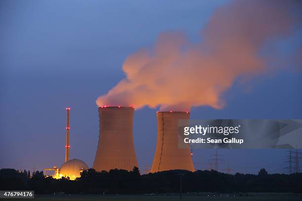 Steam rises from the cooling towers of the Grafenrheinfeld nuclear power plant at night on June 11, 2015 near Grafenrheinfeld, Germany. The...