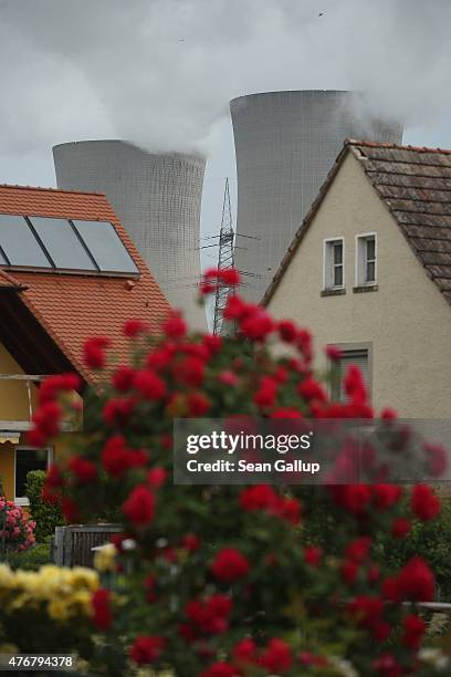 Steam rises from the cooling towers of the Grafenrheinfeld nuclear power plant near residential houses on June 11, 2015 in Garstadt, Germany. The...