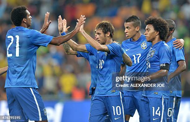 Brazil's forward Neymar celebrates with teammates after scoring his team's fifth goal during a friendly football match between South Africa and...