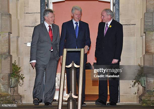 In this handout image supplied by Michael Cooper, Northern Ireland First Minister Peter Robinson, former US President Bill Clinton and deputy First...