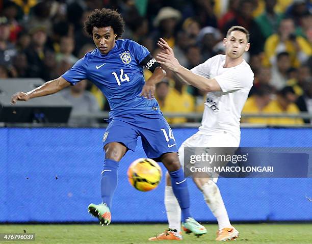 Brazil's midfielder Willian challenges South Africa's midfielder Dean Furman during a friendly football match between South Africa and Brazil at...