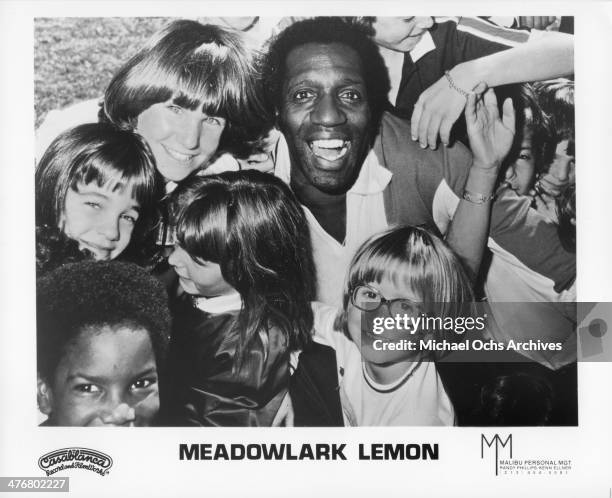 Meadowlark Lemon of the Harlem Globetrotters poses for a portrait with children circa 1970's. Lemon played with the Globetrotters from 1955-1980.