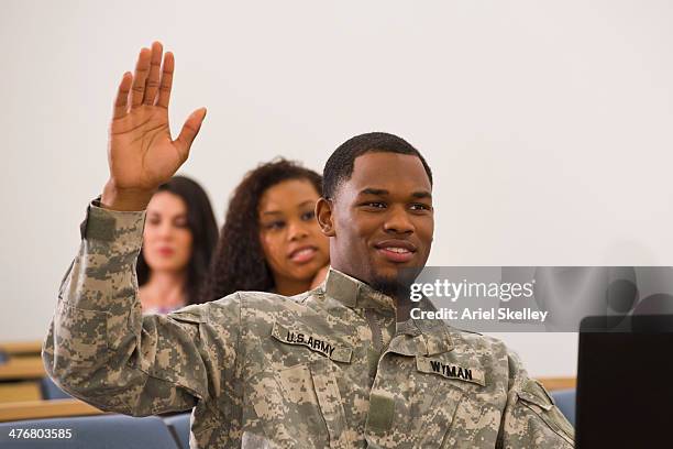 soldier raising hand in classroom - treino militar imagens e fotografias de stock