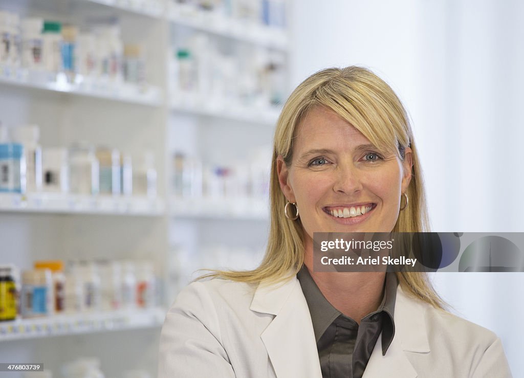 Smiling Caucasian pharmacist in pharmacy