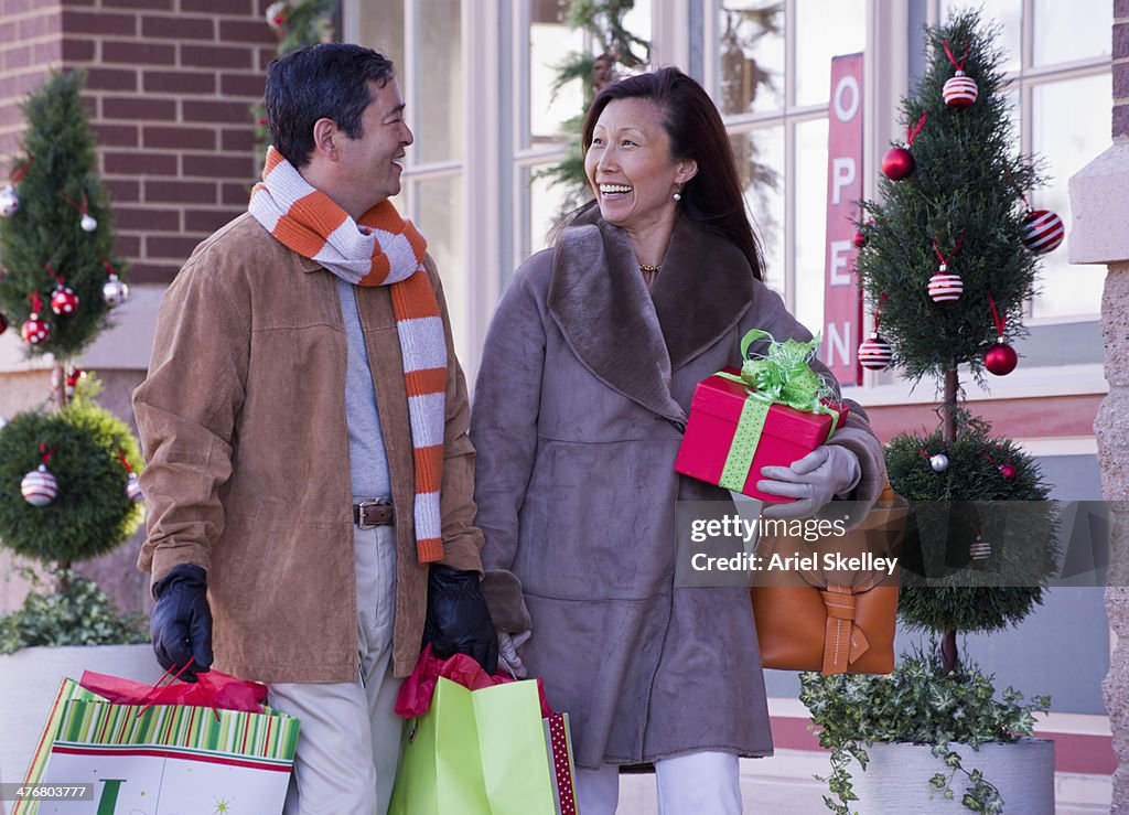 Asian couple shopping together at Christmas time