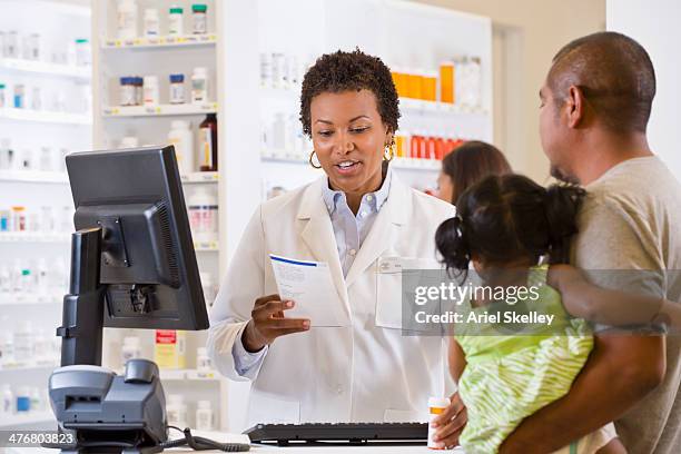 customer talking to pharmacist - black pharmacist stock pictures, royalty-free photos & images