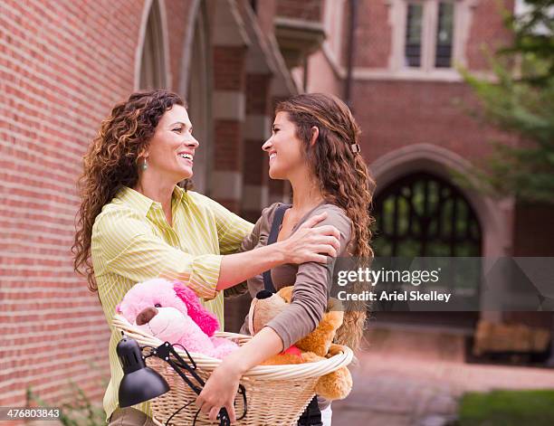 mixed race mother saying goodbye to daughter going to college - collegebasket stock pictures, royalty-free photos & images