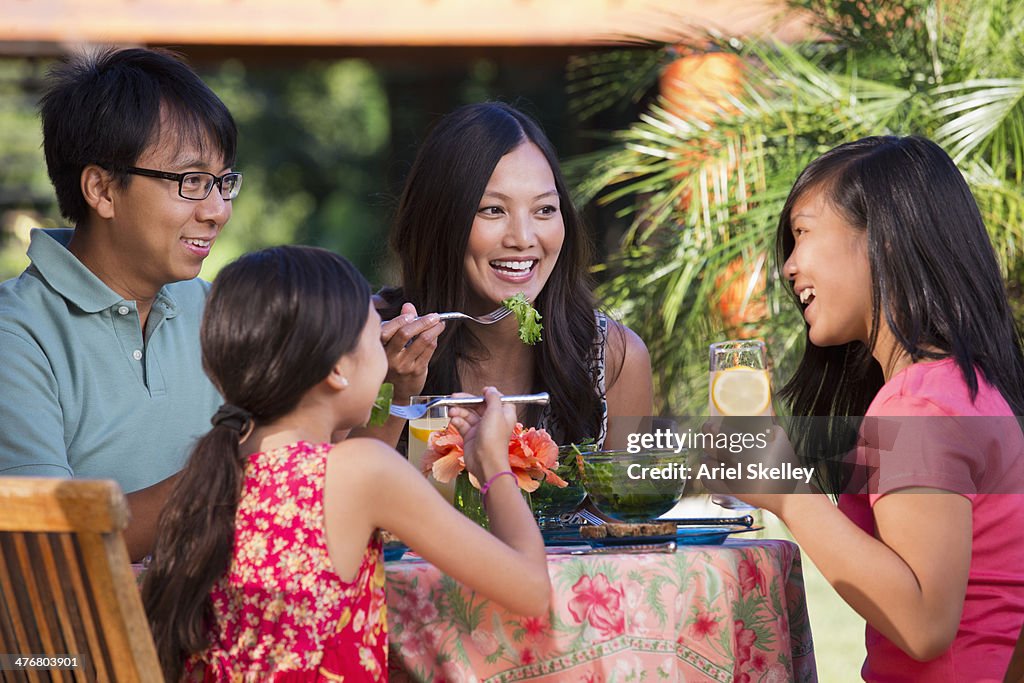Family eating together on patio