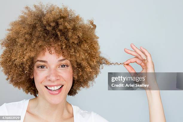 black woman playing with hair - curly hair stock pictures, royalty-free photos & images
