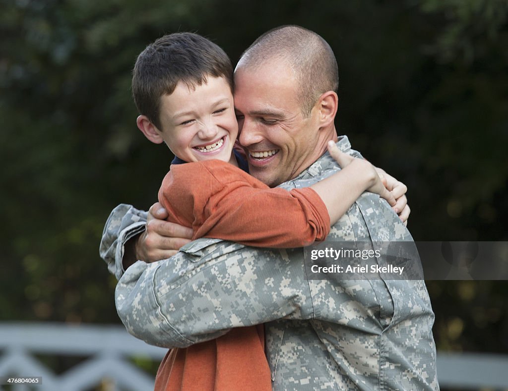 Caucasian returning soldier greeting son