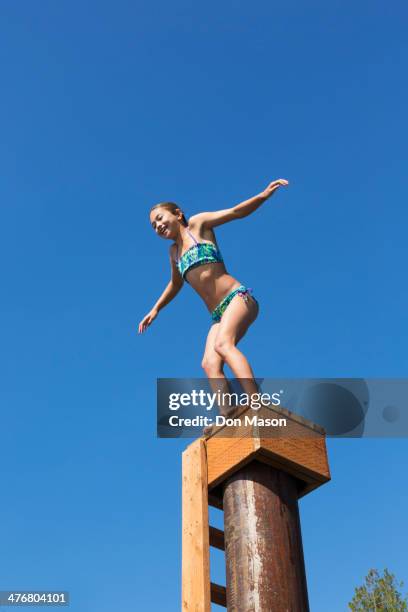 mixed race girl jumping off platform - lake whatcom bildbanksfoton och bilder