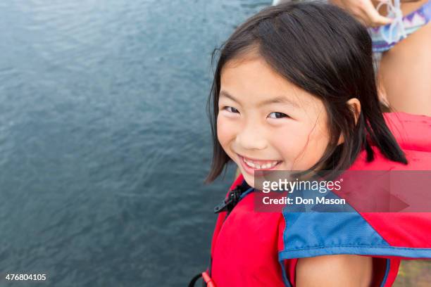 mixed race girl smiling by lake - lake whatcom foto e immagini stock