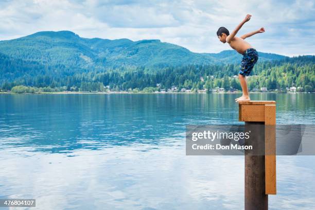 korean boy jumping off platform into lake - lake whatcom bildbanksfoton och bilder