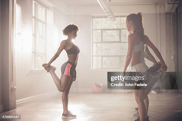 women stretching in gym - quadriceps muscle stock pictures, royalty-free photos & images