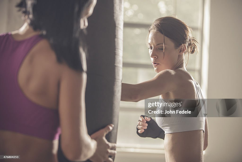 Woman working with trainer in gym