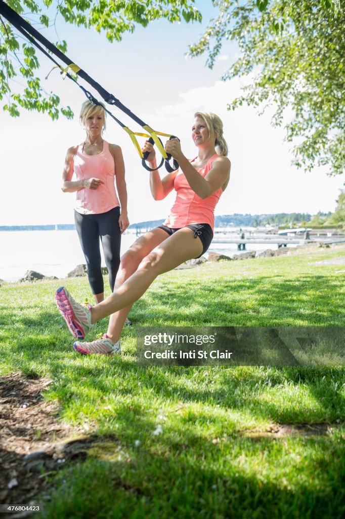 Caucasian woman working with trainer outdoors