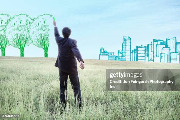 indian businessman drawing trees on sky - emissioni di co2 foto e immagini stock