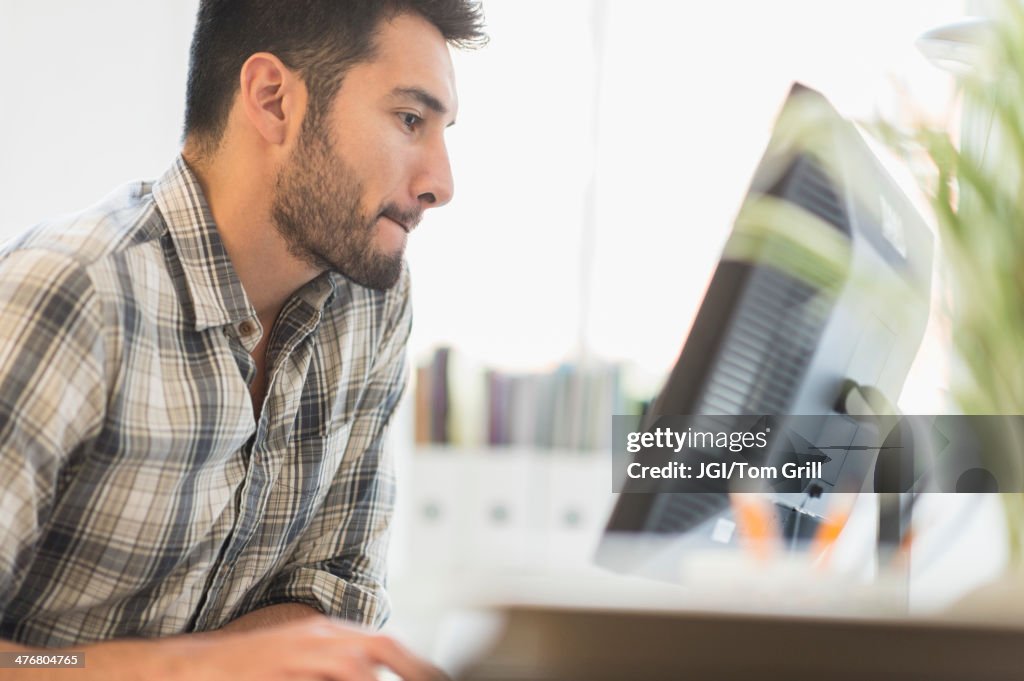 Mixed race businessman working in office