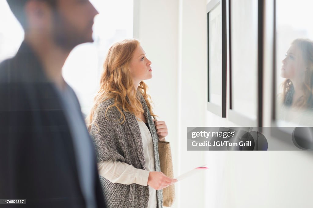 Woman admiring art in gallery