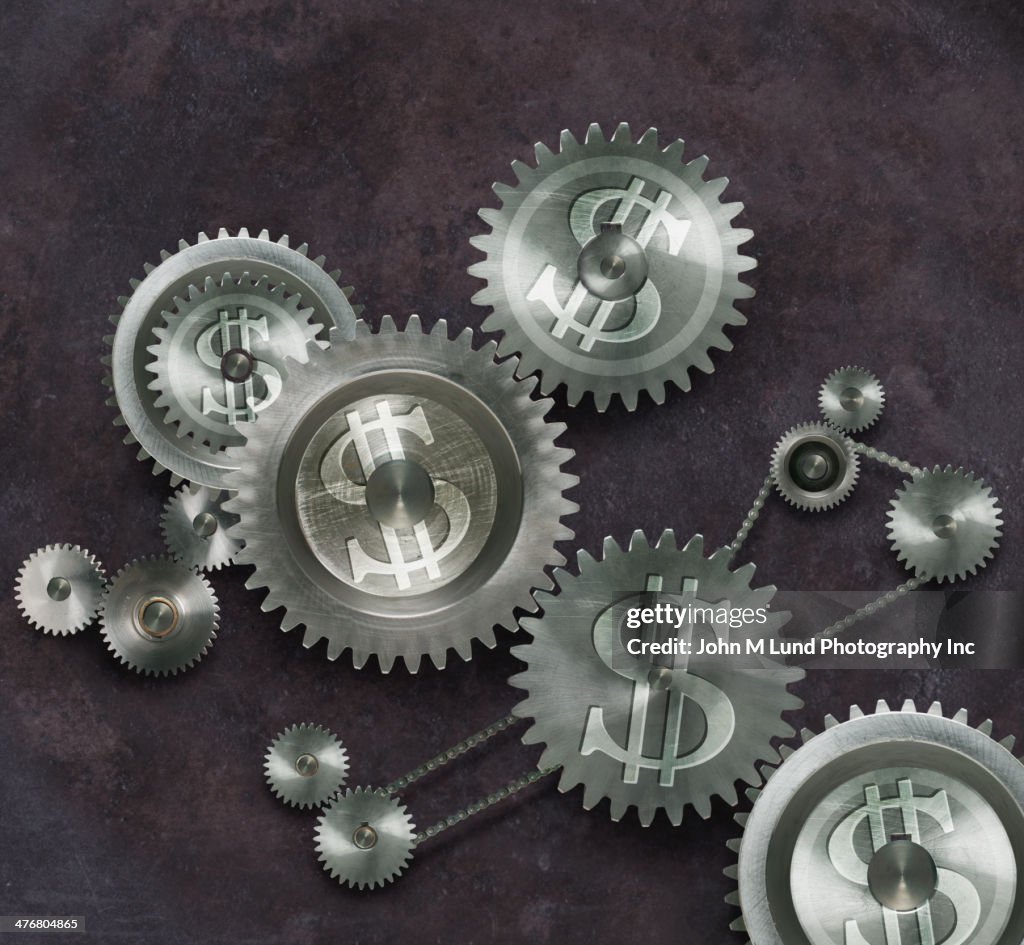 Metal cogs with dollar signs