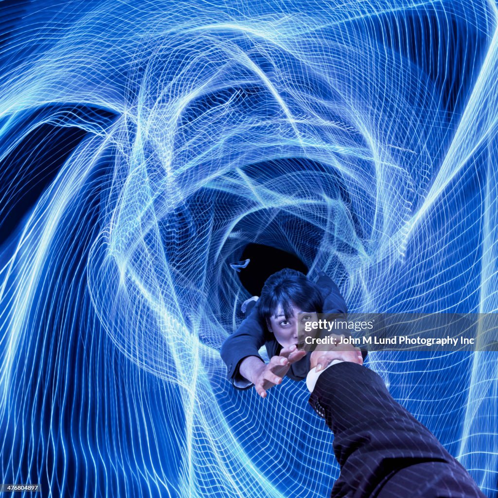 Mixed race businesswoman clinging to colleague's hand
