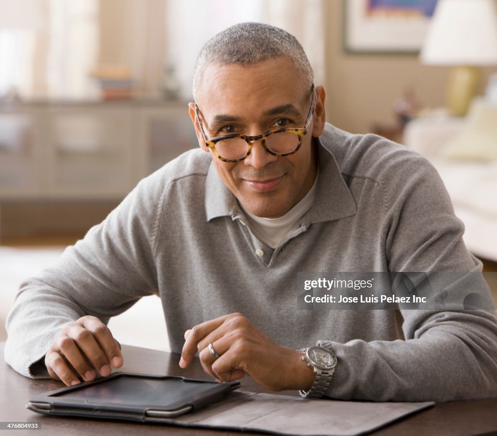 Mixed race man using digital tablet