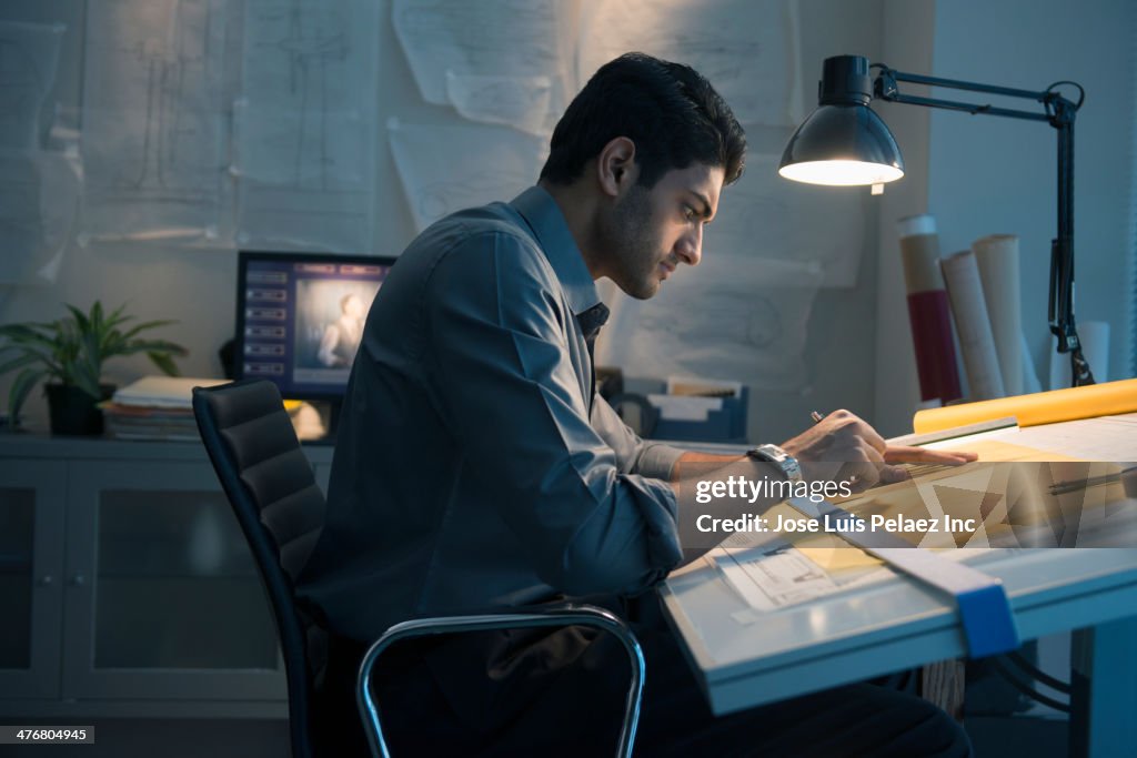 Architect working at drafting table in office