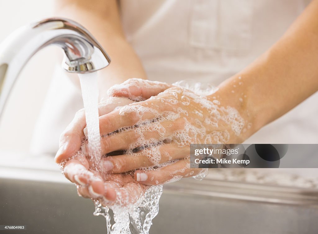 Caucasian woman washing her hands