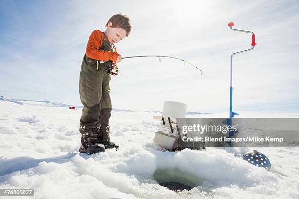 caucasian boy ice fishing - ice fishing stock pictures, royalty-free photos & images