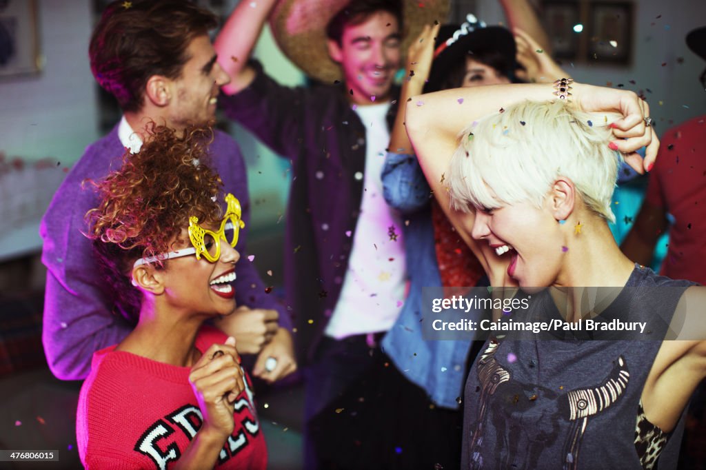 Friends dancing together at party