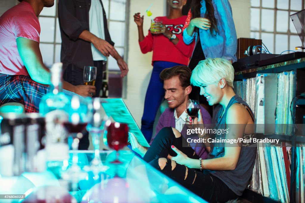 Couple looking at records at party