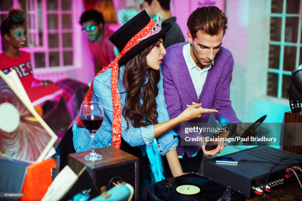 Couple playing records at party