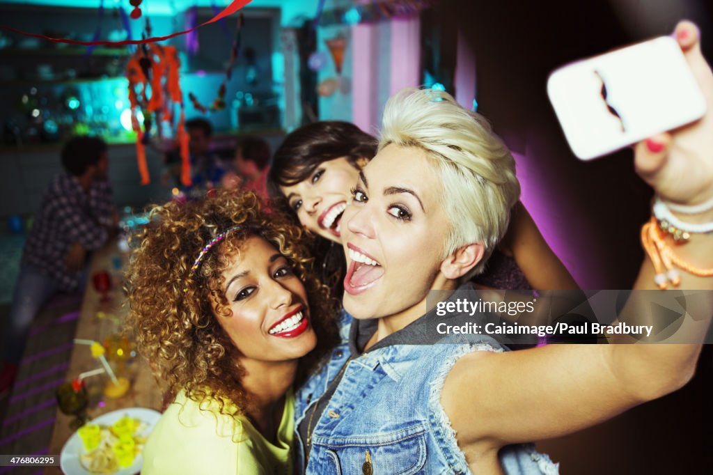 Women taking self-portrait at party