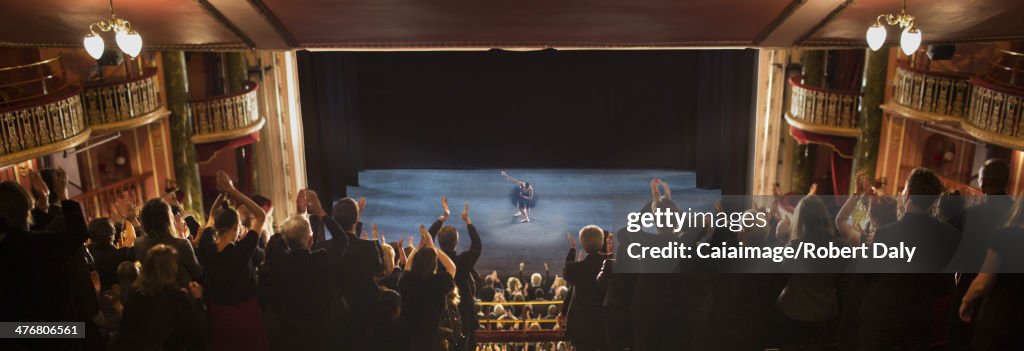 Audience applauding in theater