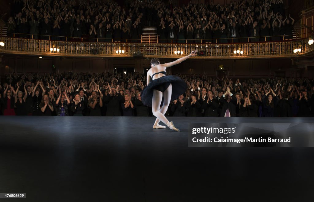 Ballerina  bowing on stage in theater