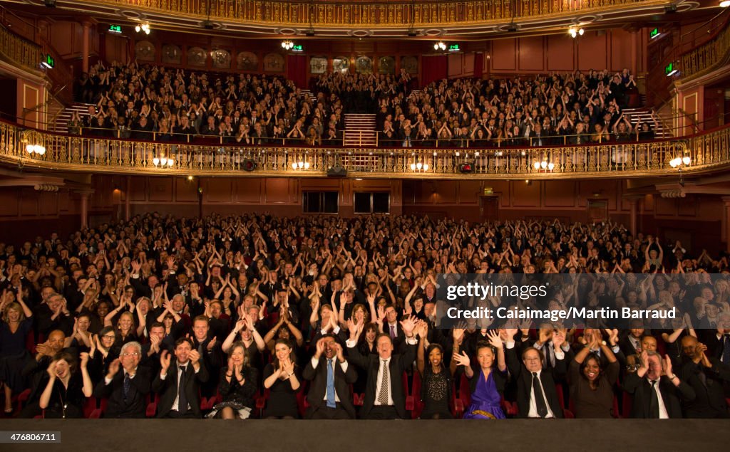 Audience applauding in theater