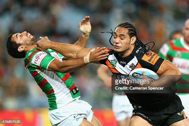 Martin Taupau of the Tigers breaks through a tackle during the round 14 NRL match between the Wests Tigers and the South Sydney Rabbitohs at ANZ...
