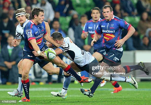 Mike Harris of the Rebels passes the ball whilst being tackled by Alby Mathewson of the Force defence during the round 18 Super Rugby match between...