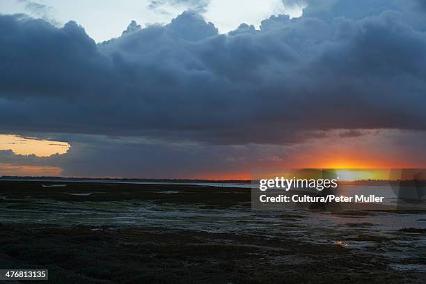 sun setting over rural lake - itchenor, west sussex stock pictures, royalty-free photos & images