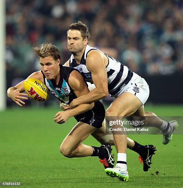 Sam Colquhoun of the Power is tackled by Jared Rivers of the Cats during the round 11 AFL match between the Port Adelaide Power and the Geelong Cats...