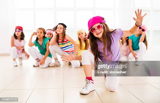 smiling little hip hop dancer looking at the camera. - kid dancing stock pictures, royalty-free photos & images