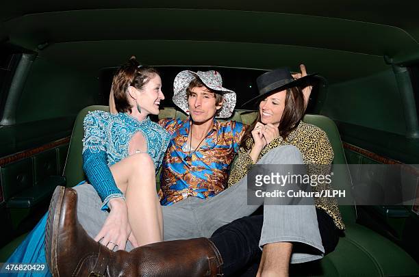 man sitting with women in limousine - limousine fotografías e imágenes de stock