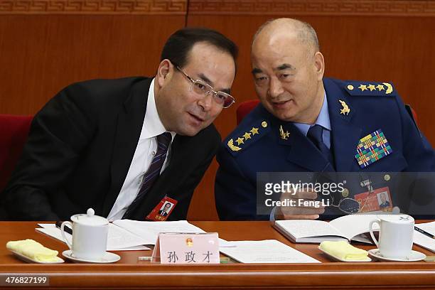 Chongqing Communist Party Secretary Sun Zhengcai talks with Chinese vice chairman of the Central Military Commission Xu Qiliang during the opening...