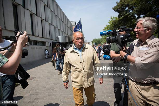 Dominique Alderweireld, who runs a chain of massage parlors and is also known as Dodo La Saumure, speaks to members of the media as he leaves the...