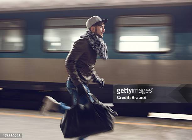 man in blurred motion trying to catch the train. - catch stockfoto's en -beelden
