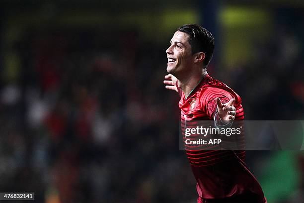 Portugal's forward Cristiano Ronaldo celebrates after scoring during the FIFA 2014 World Cup friendly football match Portugal vs Cameroon at...